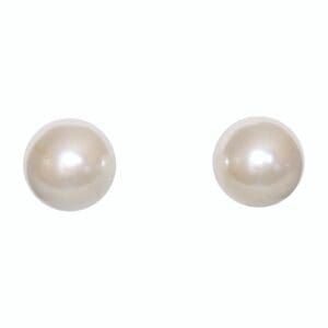 Two round white pearl earrings isolated.