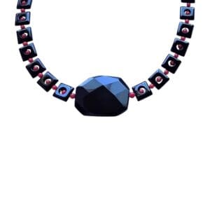 Black geometric necklace with red accents.