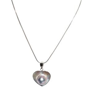 Heart-shaped pearl pendant on silver necklace.