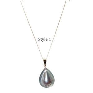 Gold chain with teardrop pearl pendant.