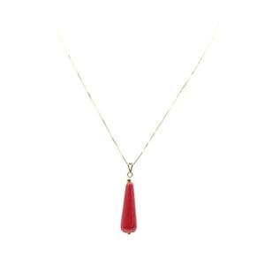 Gold necklace with red teardrop pendant.