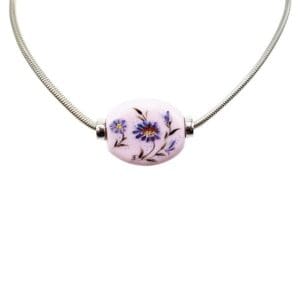 Silver necklace with floral bead pendant.