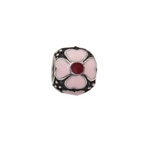 Pink floral bead with red center.