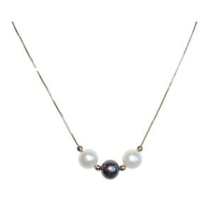 Gold chain necklace with three pearls.