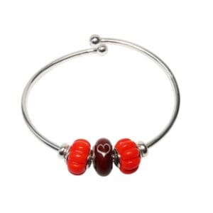 Silver bracelet with red heart beads.