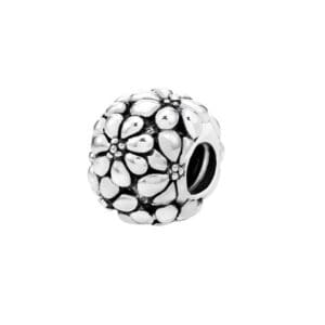 Silver bead with floral design.
