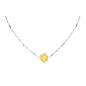 Silver necklace with yellow flower pendant.