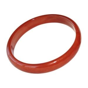 Red jade bangle bracelet on white background.
